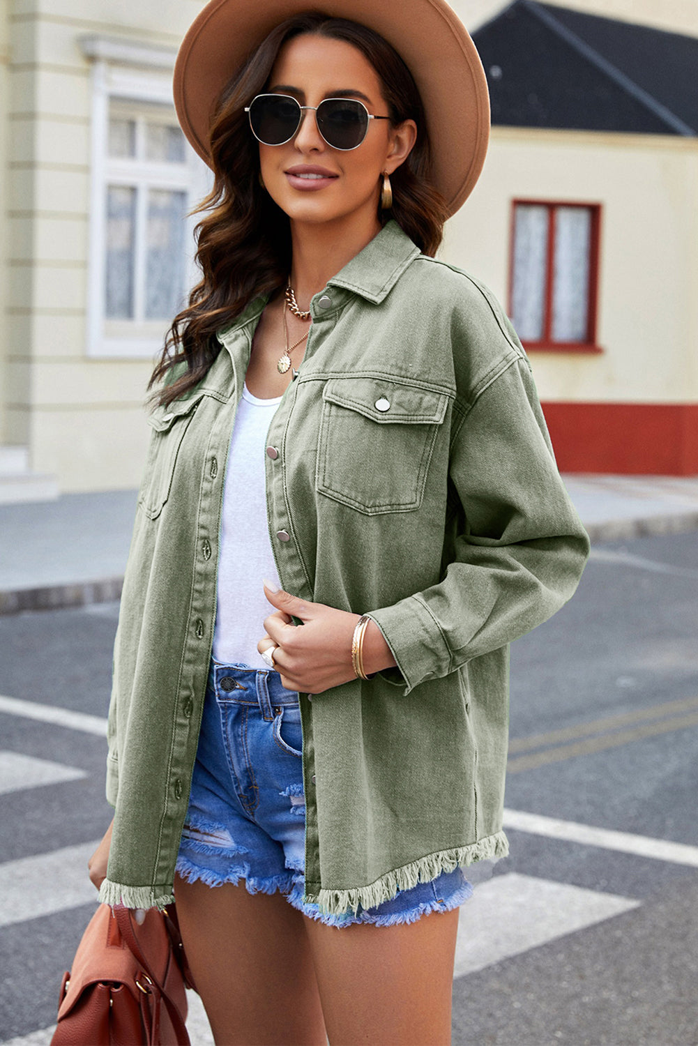 Oversized sage green denim shirt jacket with frayed hem and button front.