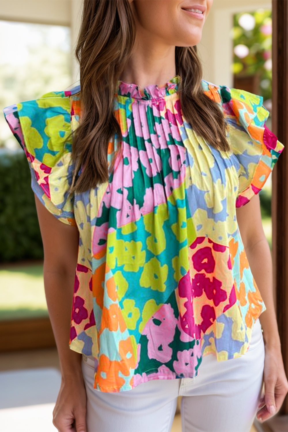 Floral ruffle yoke and flutter sleeve blouse with a high neckline and colorful floral print.