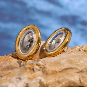 Two-tone gold oval statement earrings with a polished finish.