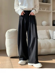 Men's black wide-leg casual trousers with drawstring detail and pockets.
