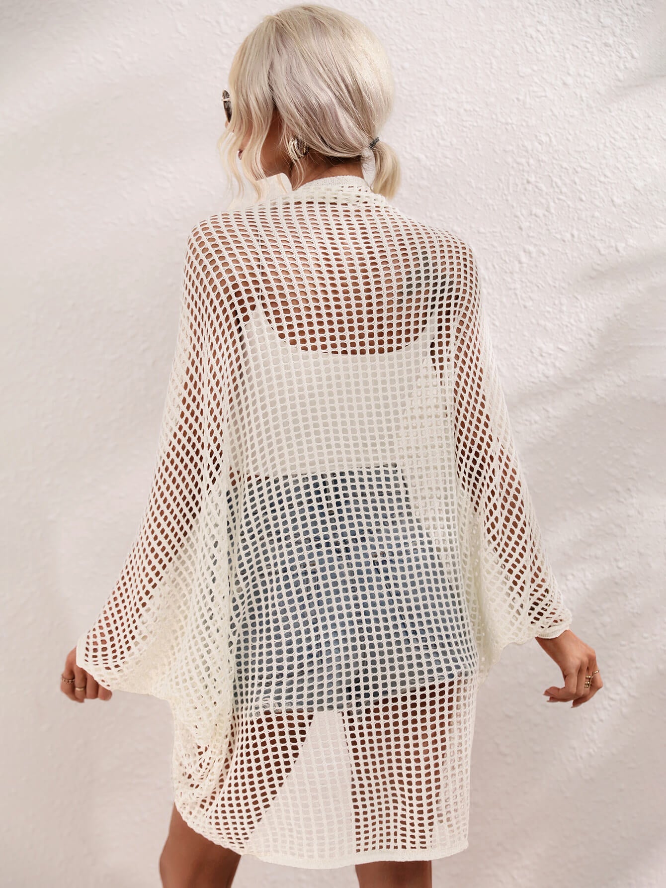 White open-weave kimono duster with batwing sleeves and a breathable acrylic knit.