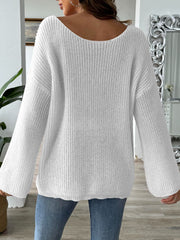White ribbed knit pullover sweater with off-the-shoulder neckline and balloon sleeves.