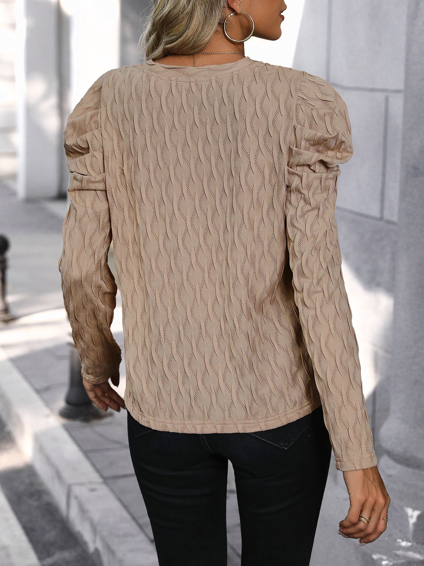 Mocha knit sweater with wave stitching and puff sleeves.