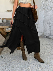 Black midi skirt with cascading ruffles and a thigh-high slit.