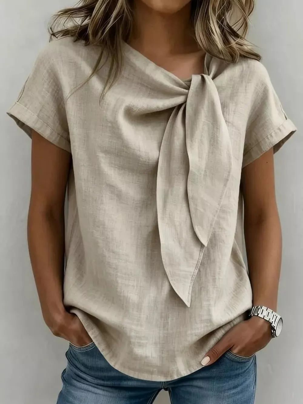 Khaki relaxed fit shirt with short sleeves and a prominent bow-tie neckline.