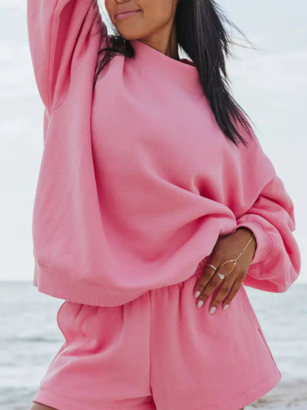 Pink crew neck sweatshirt and shorts lounge set with crew neckline and relaxed fit.