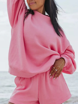 Pink crew neck sweatshirt and shorts lounge set with crew neckline and relaxed fit.