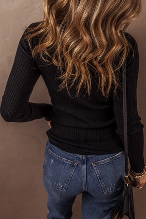 Black ribbed knit polo cardigan with long sleeves and button details.