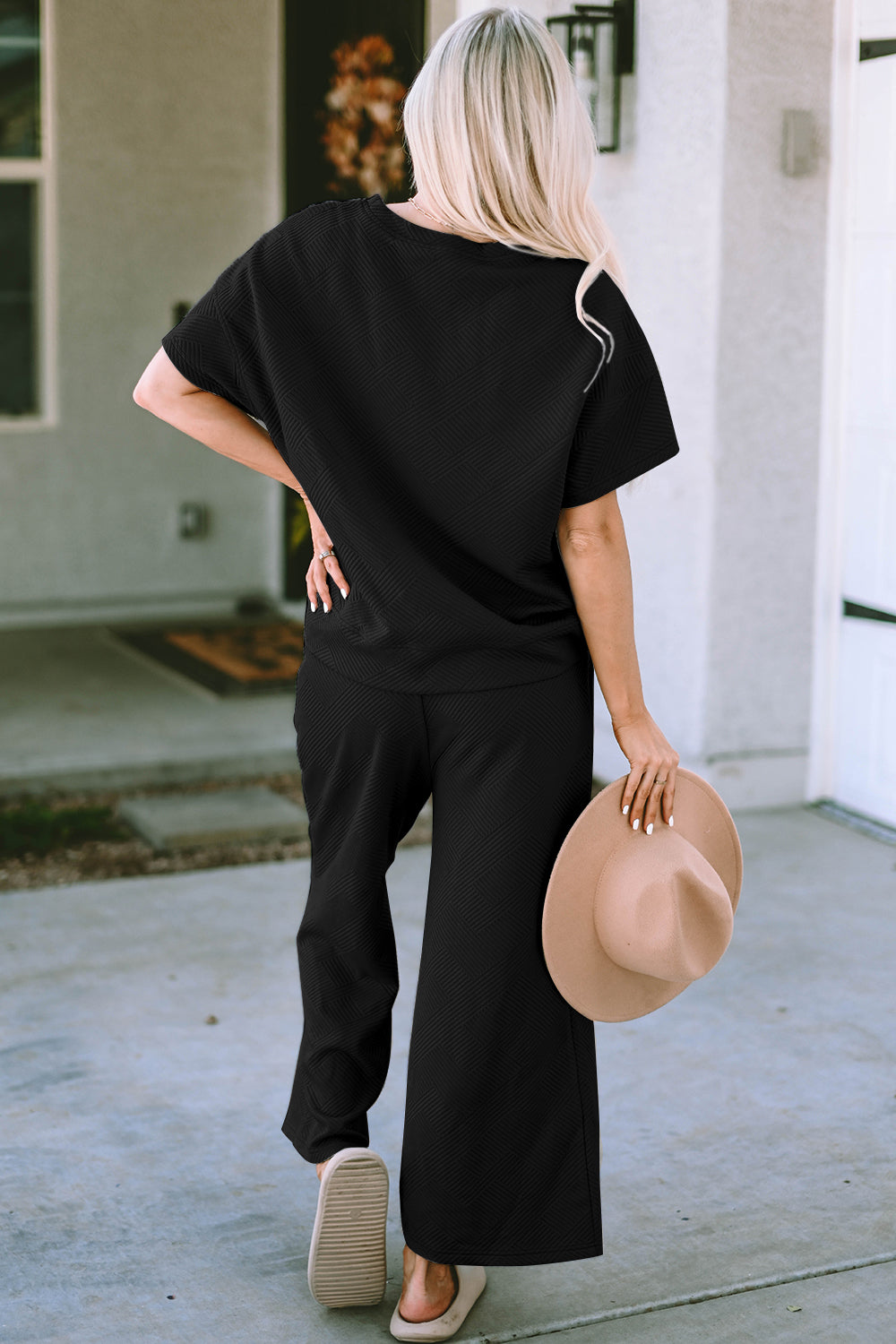 Black textured knit tee and wide leg pants set with short sleeves and a round neckline.