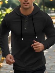 Black Henley hooded shirt with button placket and drawstring, long sleeves.