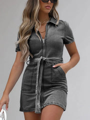 Belted denim shirtdress in dark gray with short sleeves and zip front, cinched waist with tie.