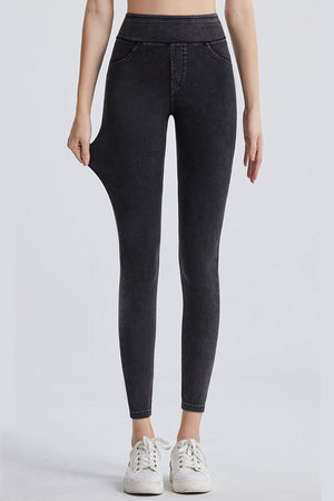 Dark gray denim leggings with faux pockets and a high waist.
