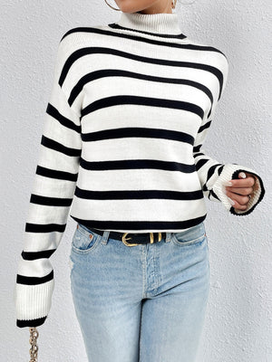 Oversized black and white striped turtleneck sweater with ribbed cuffs and hem.