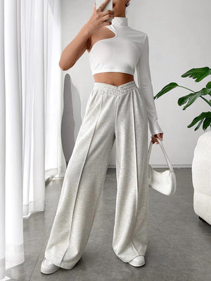 Light gray V-waistline palazzo sweatpants with center seams and wide legs.