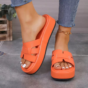 Orange leather platform caged slides with a thick sole.