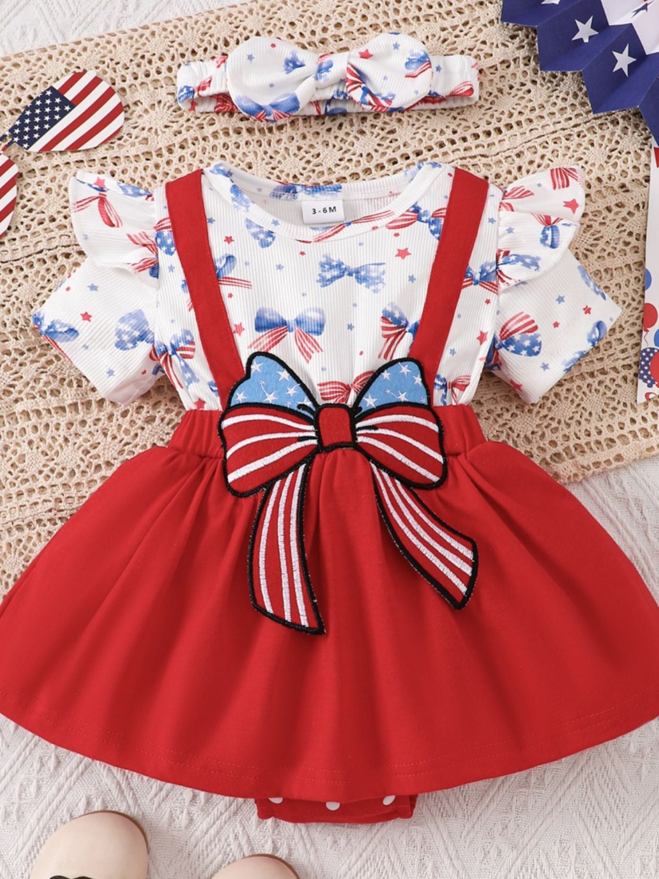 Patriotic ruffle sleeve one-piece set in red with bow detail and bow headband.
