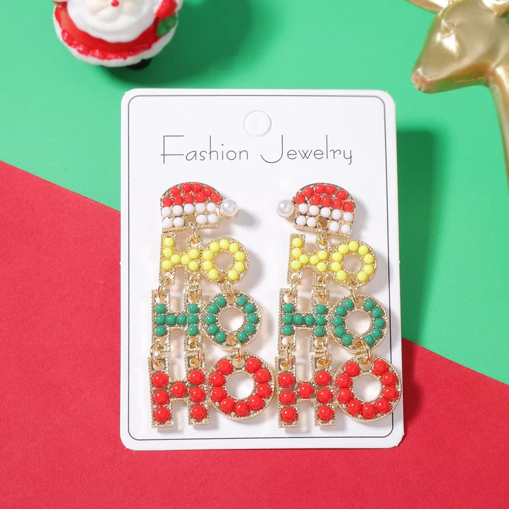 Festive holiday earrings with "HO HO HO" text, Santa hat design, red, green, yellow beads, 18k gold.