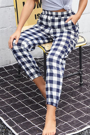 Gingham cargo joggers with elastic waist in navy and white, cuffed ankles.