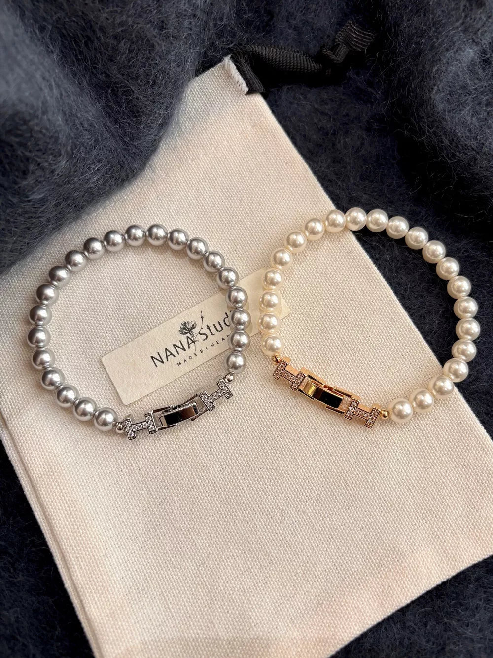 Elegant pearl bracelets in silver and gold with zircon-accented buckles.