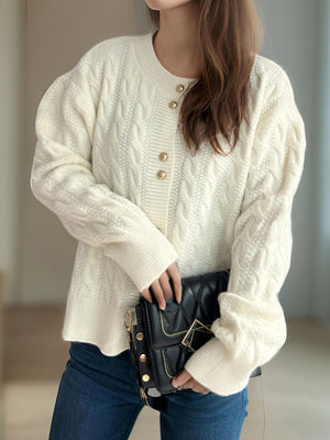 White cable knit cardigan with puff sleeves and gold buttons, acrylic material.