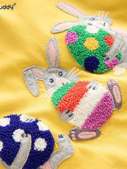 Yellow cotton blend toddler t-shirt with embroidered bunnies and colorful eggs.