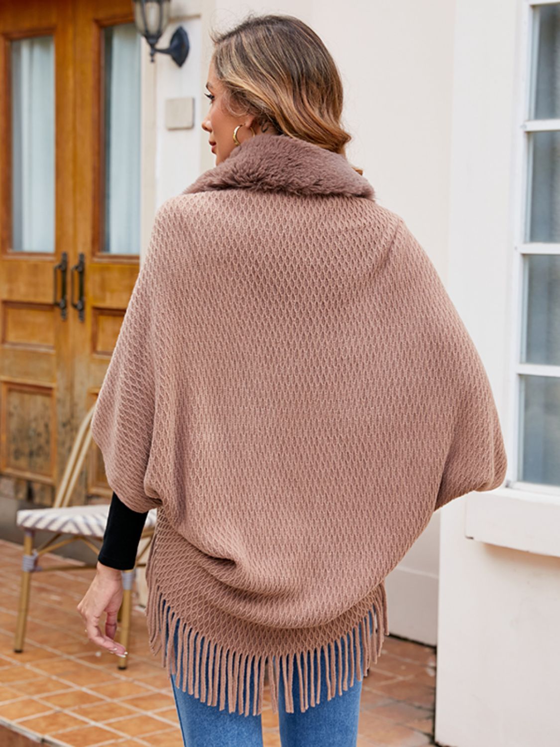 Textured knit poncho in Khaki with faux fur collar and fringe hem.