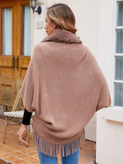 Textured knit poncho in Khaki with faux fur collar and fringe hem.