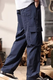 Navy cargo pants with drawstring and flap pockets, styled casually.