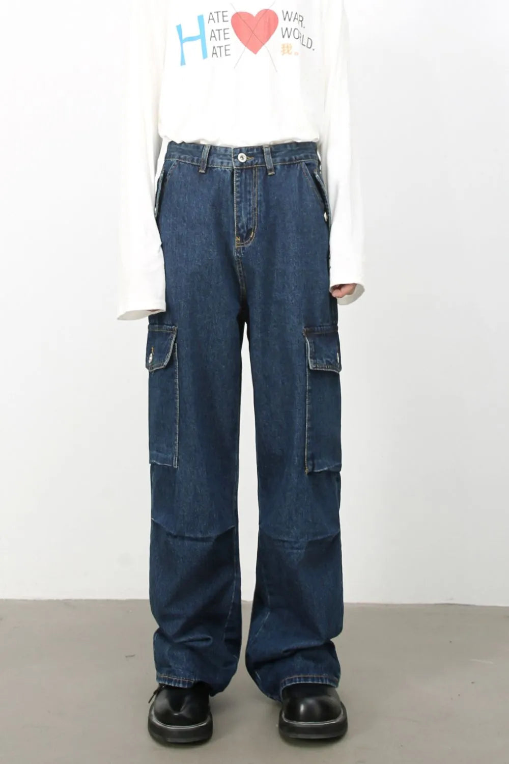 Denim palazzo cargo pants in dark wash with multiple pockets and a baggy fit.