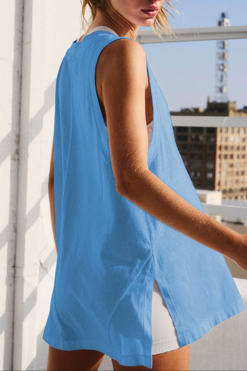 Blue oversized V-neck tank top with side slits and a relaxed fit.