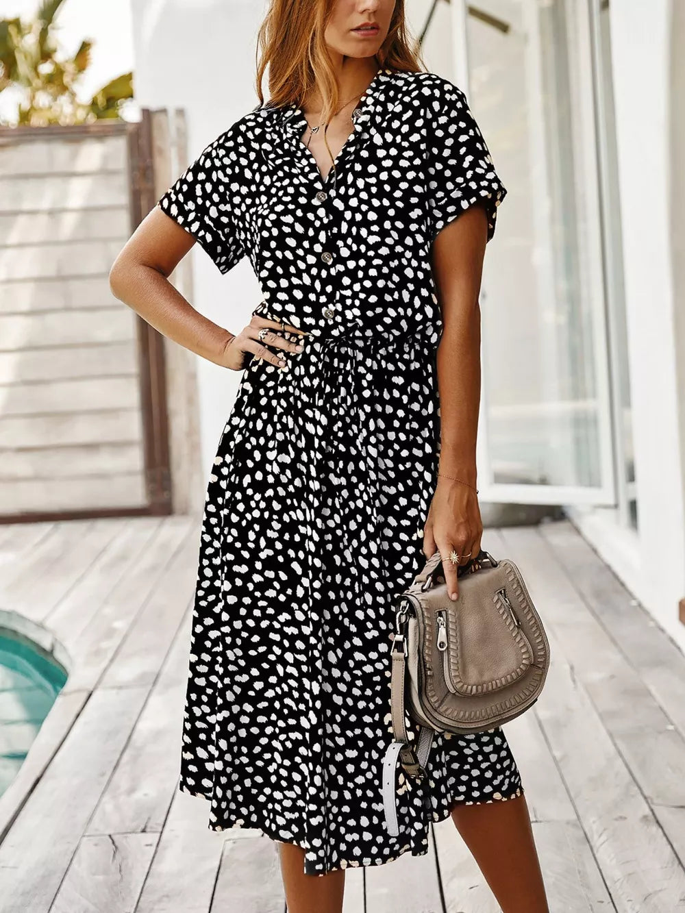 Chic animal print midi dress with tied waist, button-down neckline, and short sleeves.
