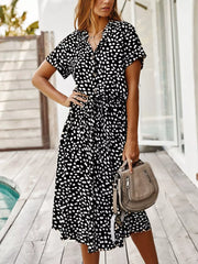 Chic animal print midi dress with tied waist, button-down neckline, and short sleeves.