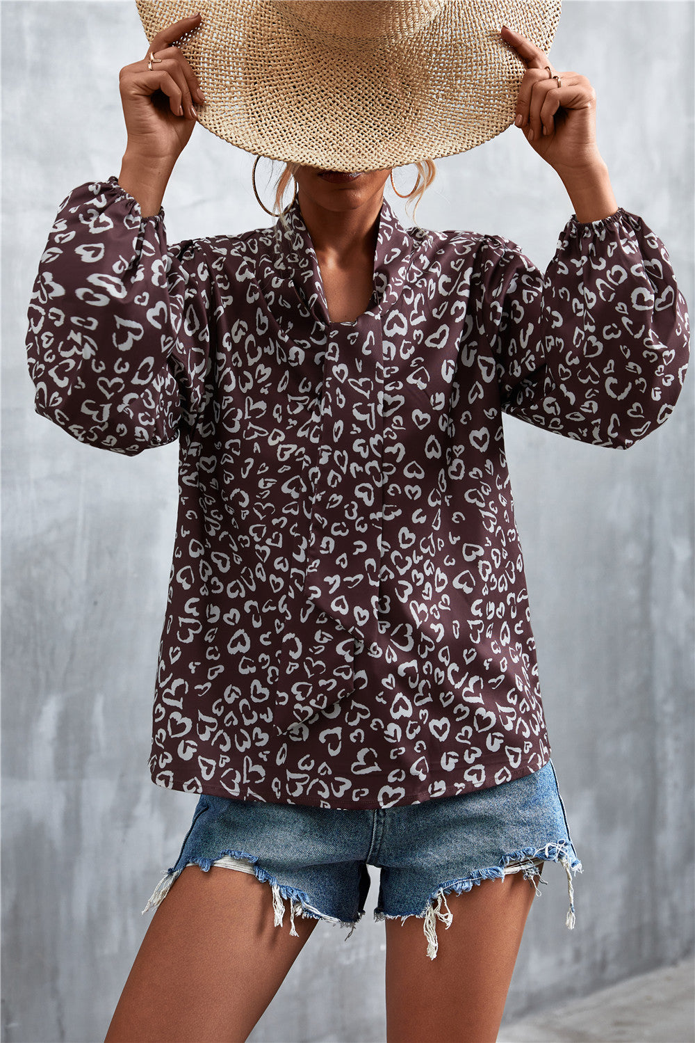 Brown abstract heart print pussy bow blouse with balloon sleeves.