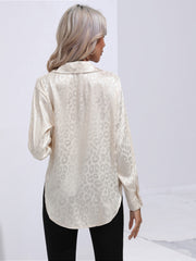Champagne satin leopard print button-down shirt with a collared neckline and long sleeves.