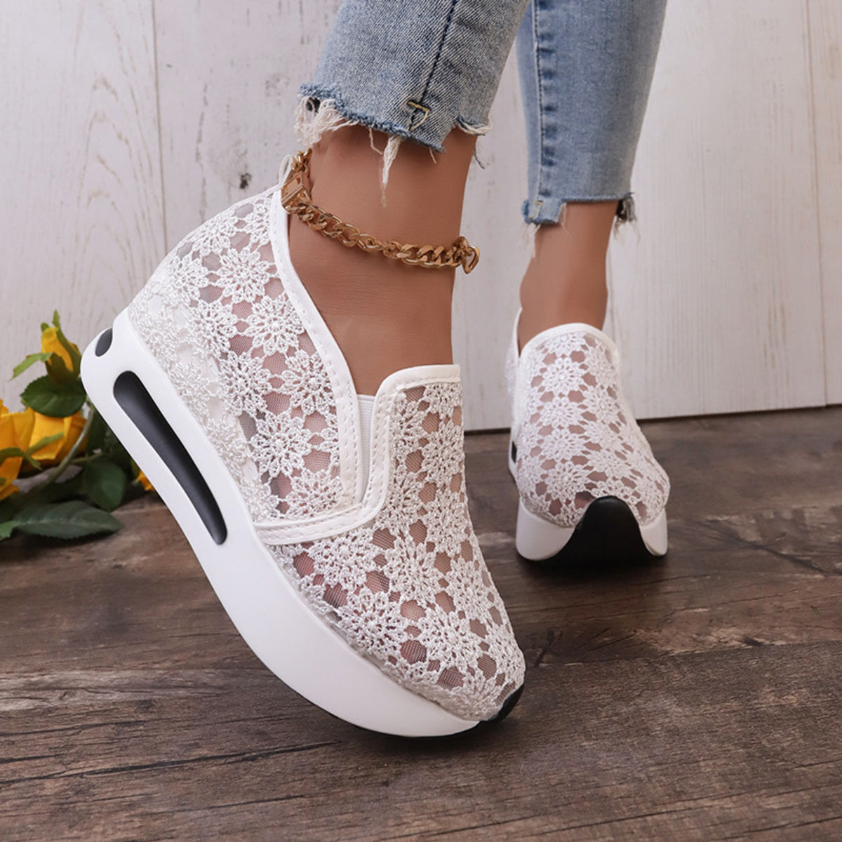 White floral lace slip-on sneakers with a chunky sole and breathable mesh upper.