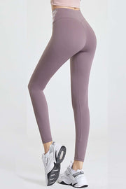 Mauve active leggings with a high waist and contour detail, shown from the back.