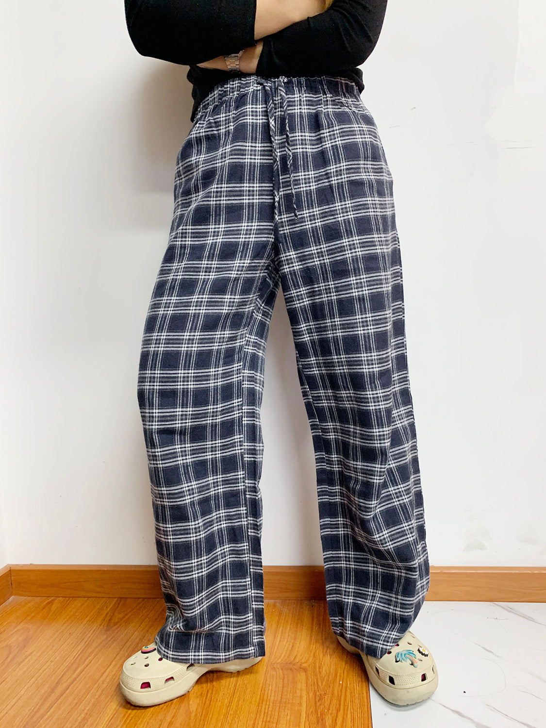 Relaxed plaid drawstring palazzo pants in dusty blue with a wide leg and checkered pattern.