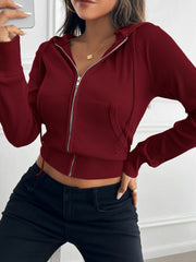 Burgundy ribbed crop zip hoodie with front pockets and silver zipper.