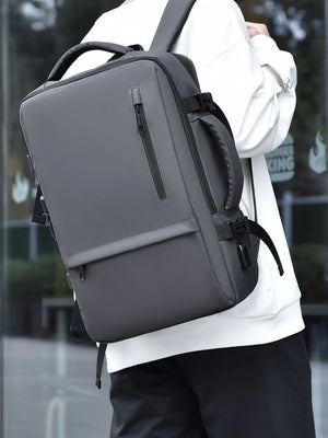 Dark gray convertible commuter backpack with multiple zippered pockets and padded straps.