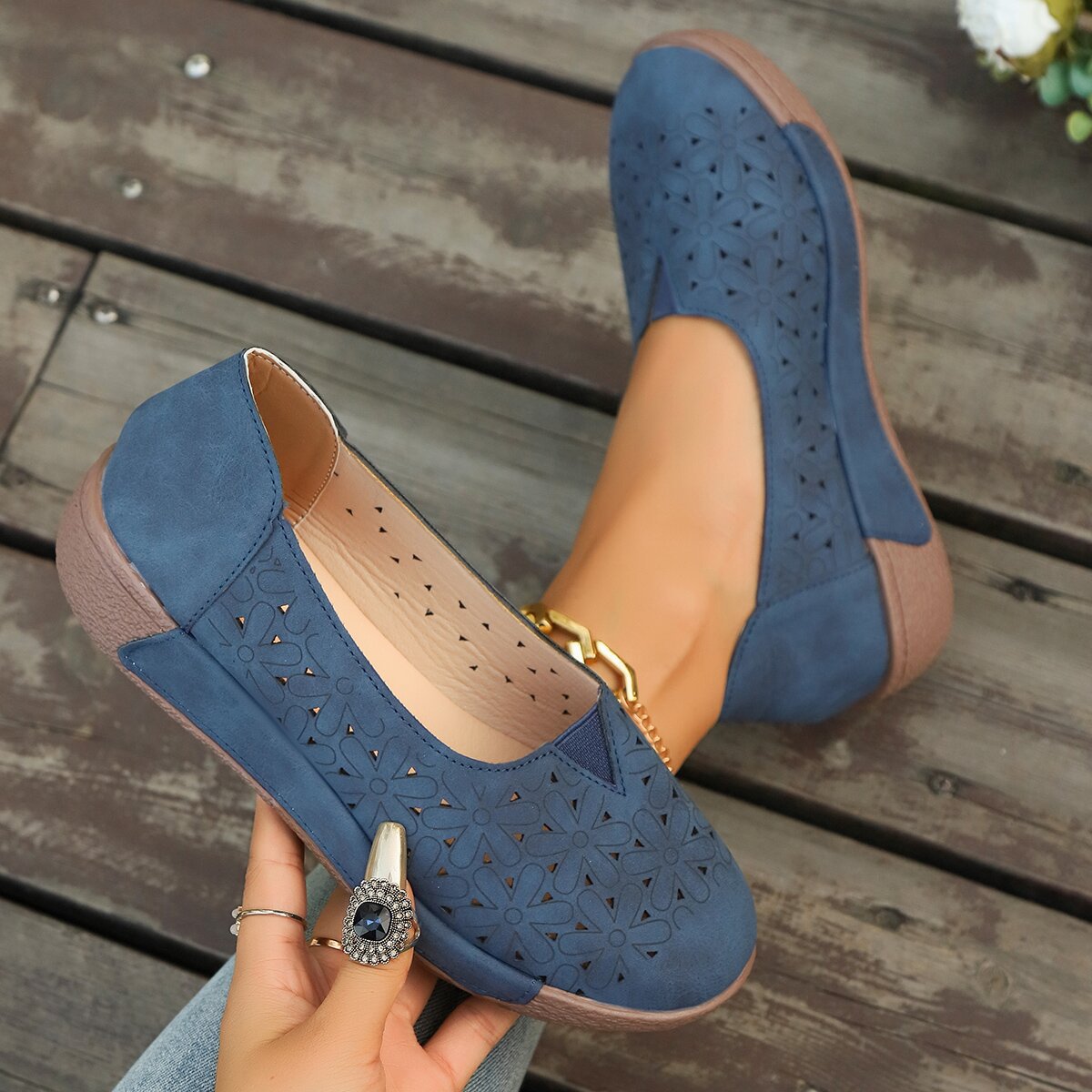 Blue floral cutout slip-on loafers with breathable design.