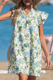 Floral v-neck mini dress with ruffled sleeves in white with blue and green floral print.