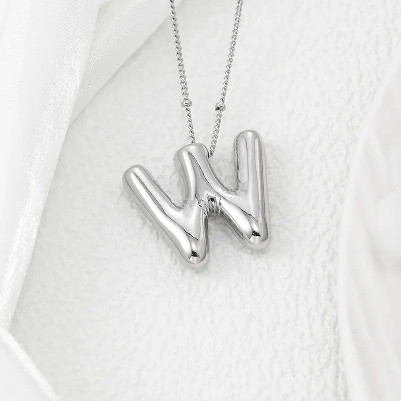 Silver letter pendant necklace with bubble font on a delicate chain