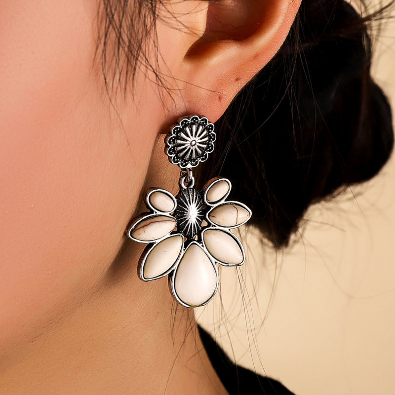 Floral drop earrings with white petals and silver alloy detail.
