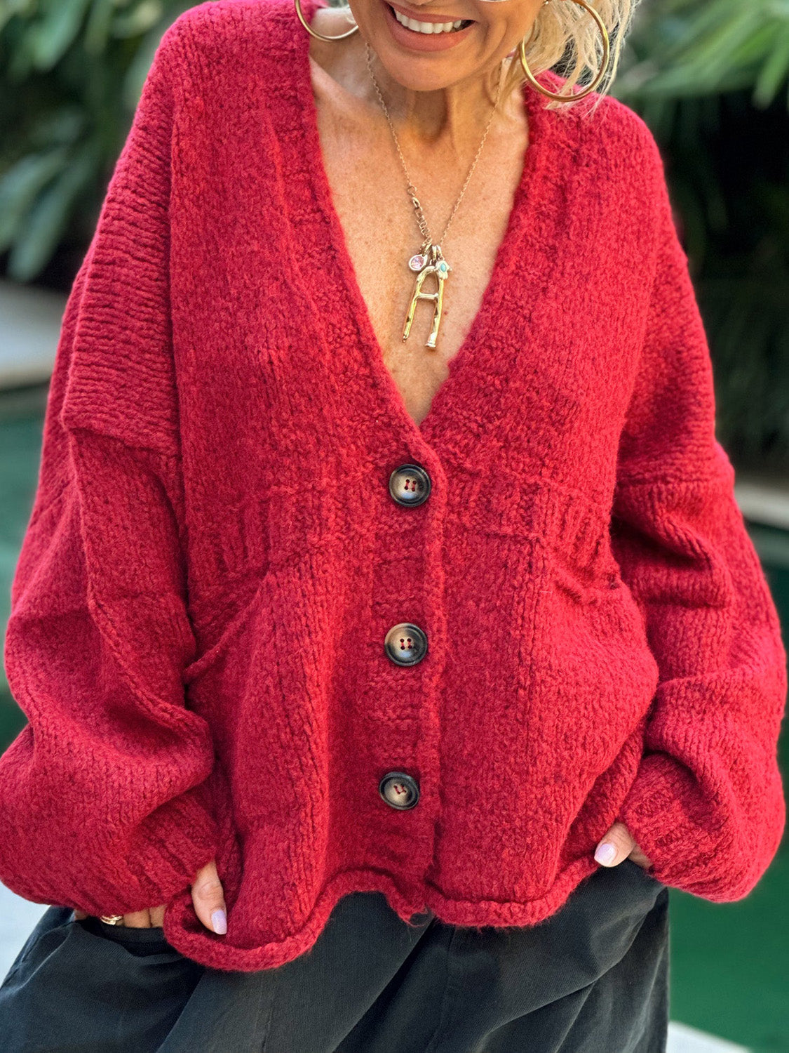 Deep Red bouclé oversized button-down cardigan with textured knit and button closure.