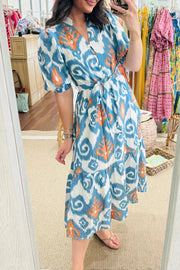Ikat floral midi dress with puff sleeves, v-neck, tie waist, and tiered skirt.