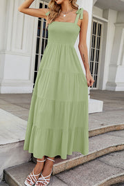 Light green tiered ruffle smocked bodice maxi dress with tie straps.