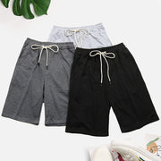 Relaxed culotte lounge shorts in black, grey, and light grey with drawstring waists.