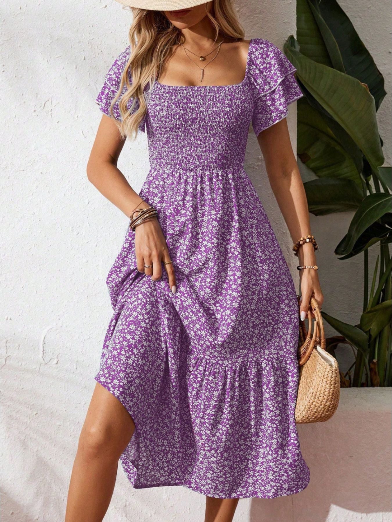 Purple floral smocked midi dress with ruffle sleeves and tiered skirt.