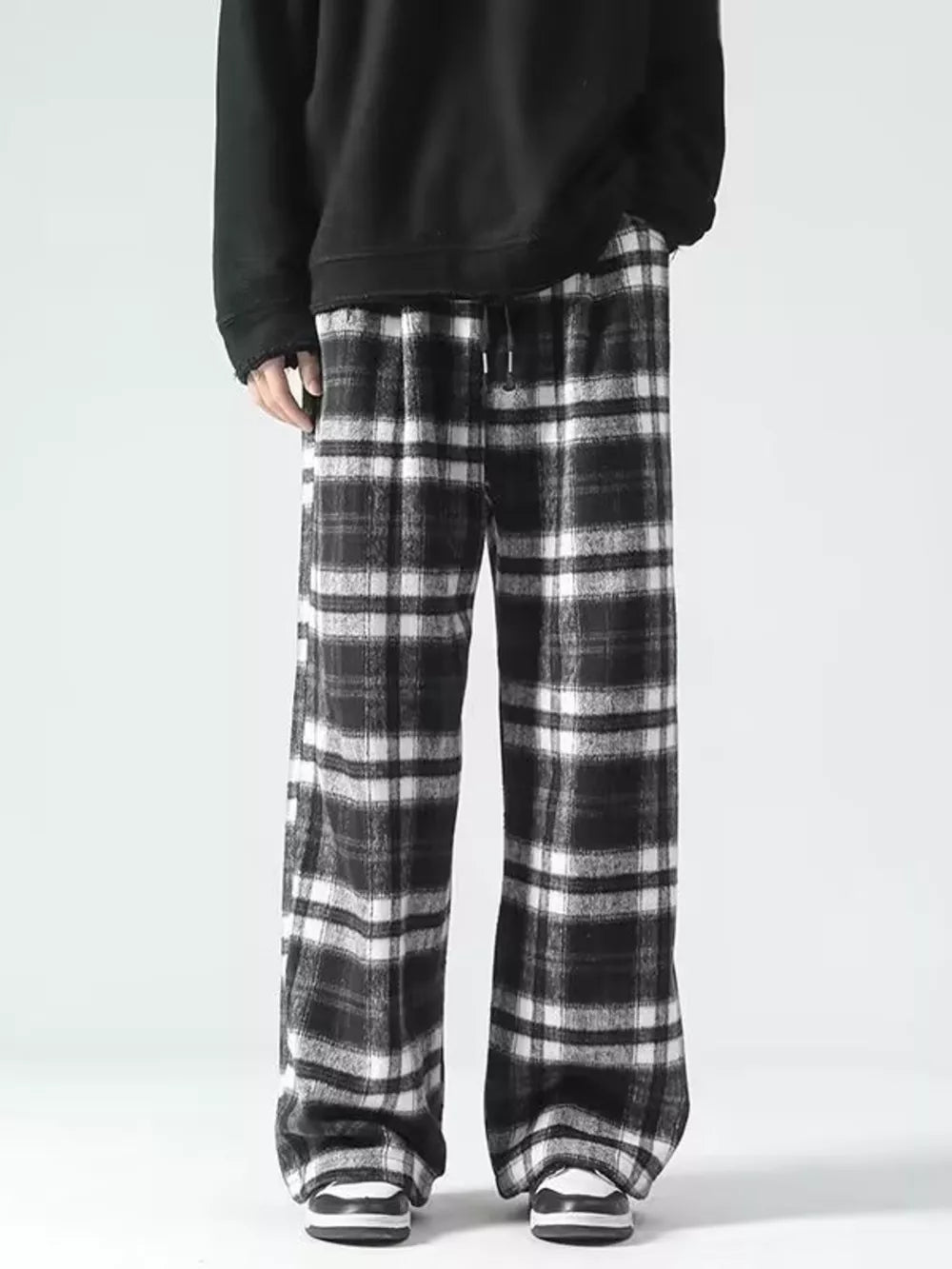 Black and white plaid wide-leg sweatpants with drawstring waist.