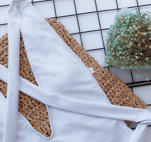 White wrap-around halterneck plunge swimsuit with crisscross detail.